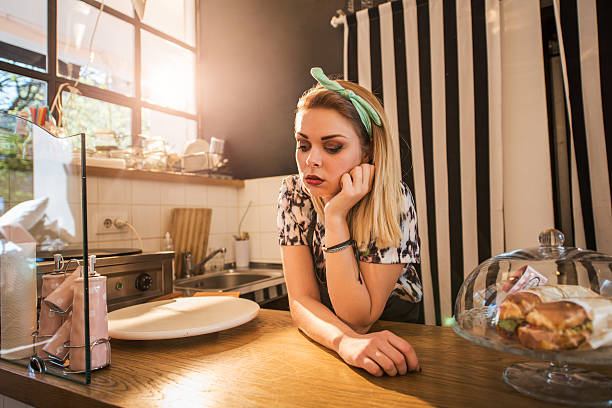 istock Bored retro styled female worker waiting for her customers. 485375990