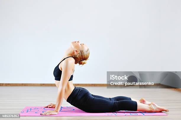 Woman In The Cobra Yoga Pose Stock Photo - Download Image Now - 2015, Adult, Adults Only