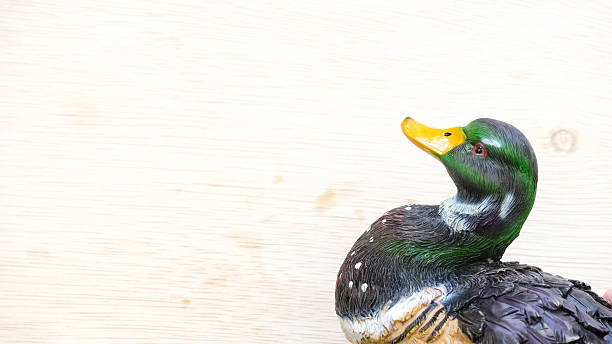 Colourful mallard or wild duck figure on wooden surface. Slightly de-focused and close-up shot. Copy space.