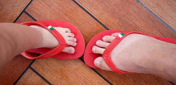istock mum and child trying on same size shoes 485376893