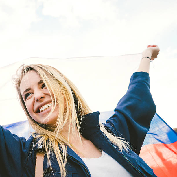 istock Cheering Woman Under Russian Flag 485376964