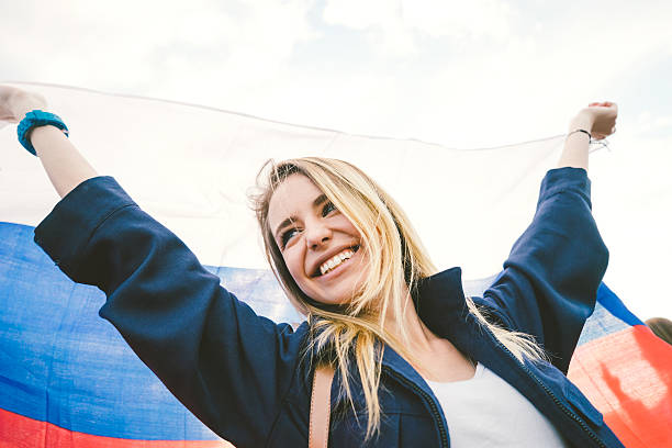 istock Cheering Woman Under Russian Flag 485376970