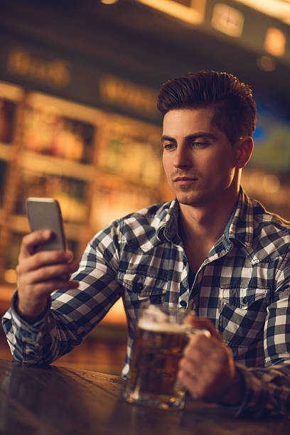 istock Young man text messaging on mobile phone in a cafe. 485377042