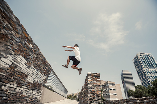Young man practicing parkour in the city
