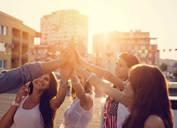 istock Happy friends at the rooftop doing high five 485377550