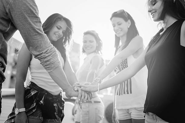 istock Happy friends at the rooftop putting hands together 485377552