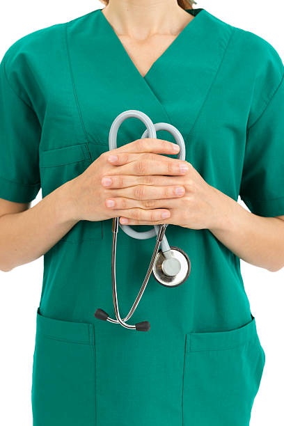 istock Doctor in green scrubs holding stethoscope 485378010