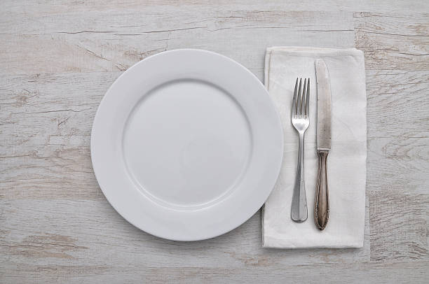 istock Plate, cutlery and cloth on wood 485380388