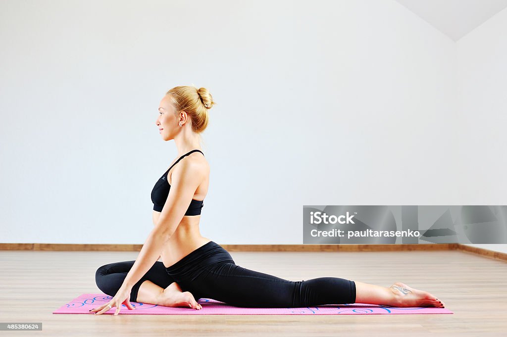 Beautiful caucasian woman exercising yoga indoors 2015 Stock Photo