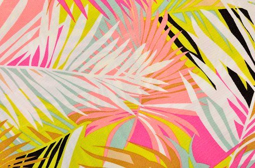 Pink, yellow and white palm leaves print as background.