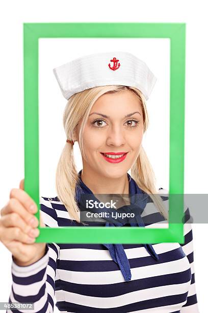 Young Female Sailor Holding A Green Picture Frame Stock Photo - Download Image Now - 20-29 Years, 2015, Adult