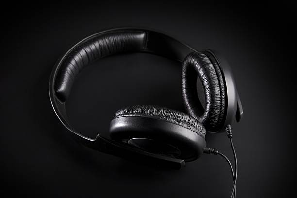 istock Black Headphones on a black background 485381576