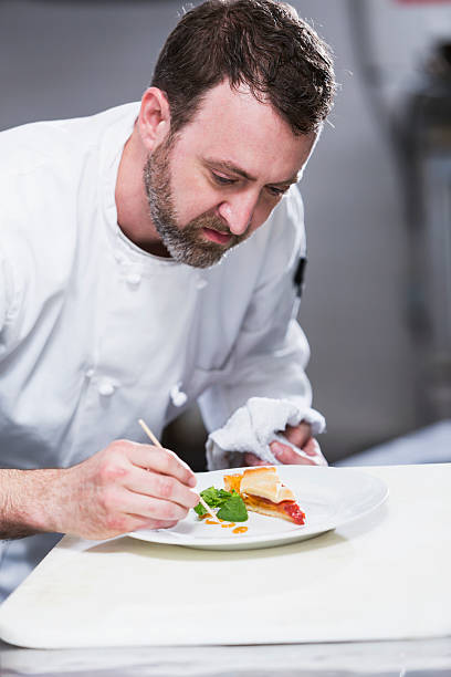 istock Chef in a restaurant plating food 485381818