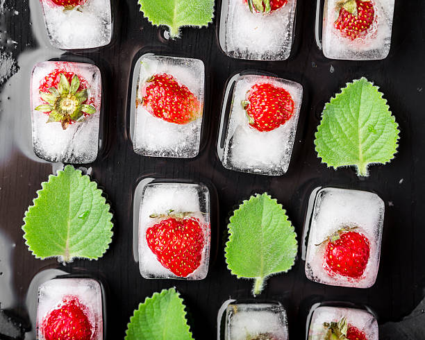 istock Ice cubes with strawberries and fresh mint leaves 485381964