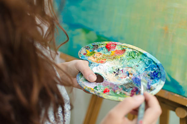 istock Woman painting 485384458