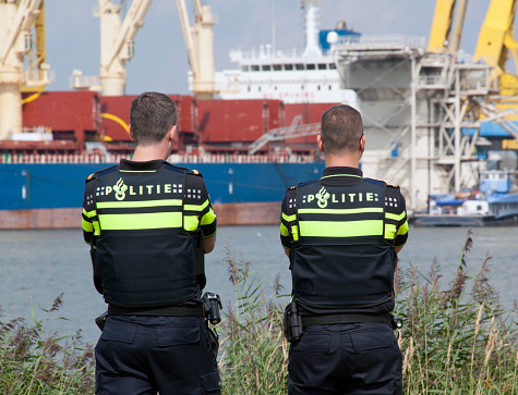 Amsterdam , Netherlands-august 19, 2015: Two Police officers on patrol in the harbour of Rotterdam