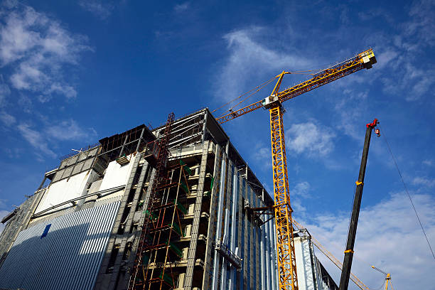 istock Crane and building construction site against blue sky 485389962