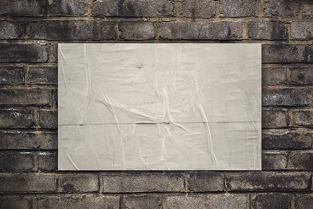 istock Glued Rustic Poster Paper on Old Brick Wall 485390302