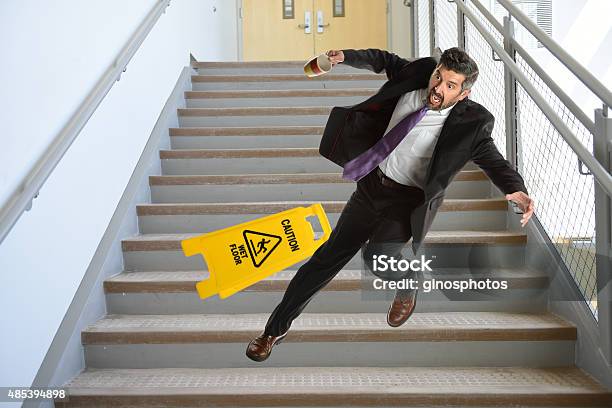 Hispanic Businessman Falling On Stairs Stock Photo - Download Image Now - Falling, Staircase, Misfortune