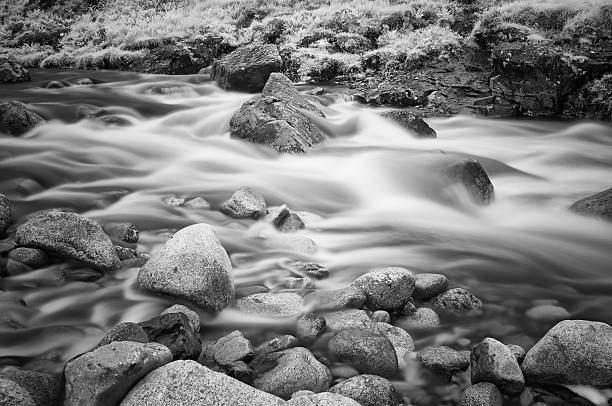 River Etive n Black And White The River Etive flows down Glen Etive. A long exposure captures the water flowing through one spot where the river narrows. Black & white conversion of an infrared image. etive river photos stock pictures, royalty-free photos & images