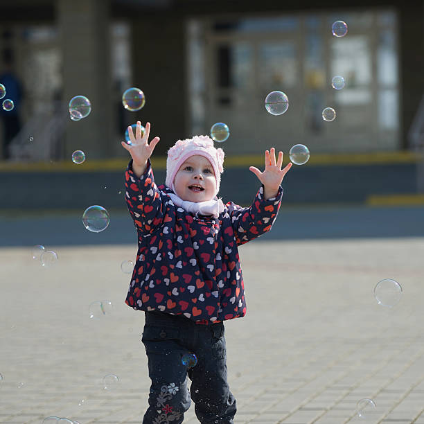 istock little girl plays with bubbles 485395546