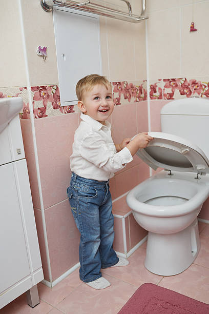istock little boy looks in toilet 485395564