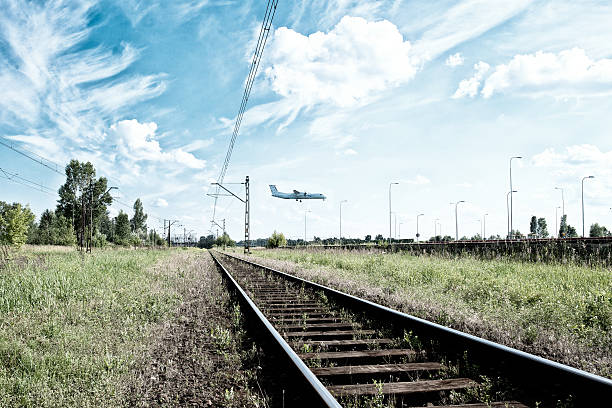 railway and airplane in background on a beautiful sunny day