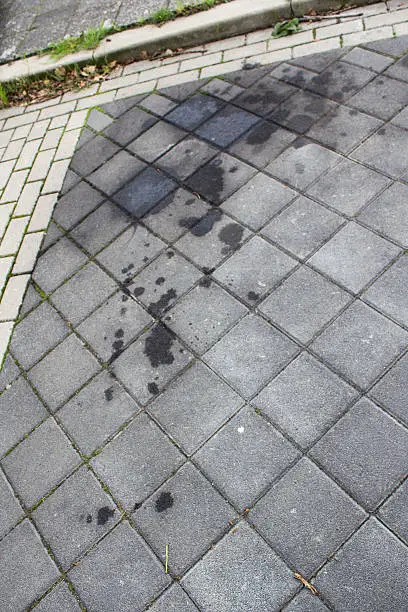 Oil stain, spill on a parkingspot, parkingplace, street, car motor, bike, truck