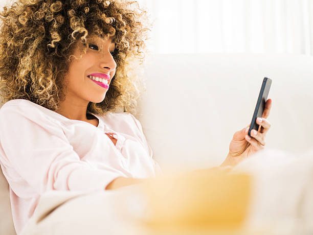 istock African American woman reading a text message on cell phone. 485400924