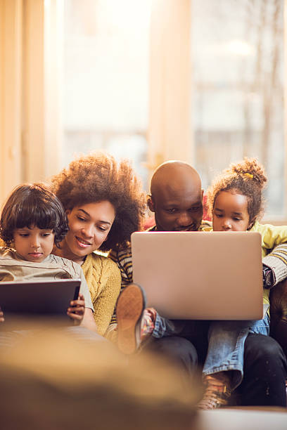 istock African American family using wireless technology at home. 485404368