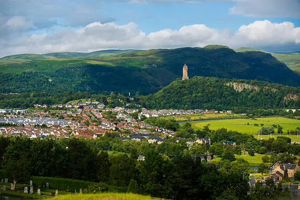 A view of the town of Stirling, Scotland with the William Wallace Monument in the distance.