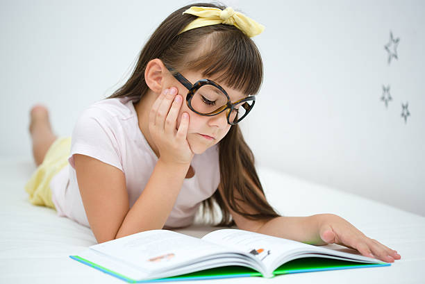 istock Little girl is reading a book 485405058