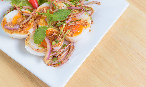 istock thai food spicy minced boiled egg salad on white dish 485405686