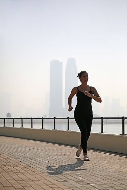 istock Runner woman excersizing in park over the cityscape 485405828