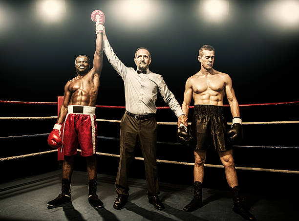 Winner of the boxing fight Referee raining arms of the winner defeat stock pictures, royalty-free photos & images