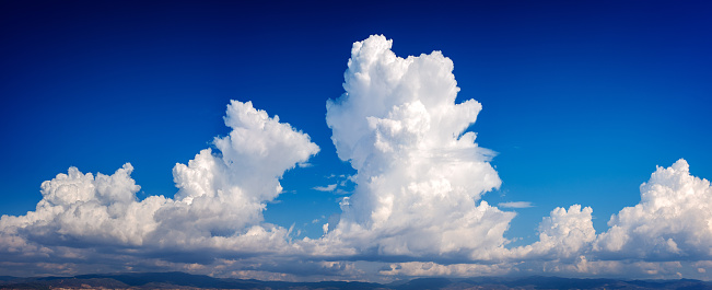 A panoramic skyscape with a variety of clouds in summer.