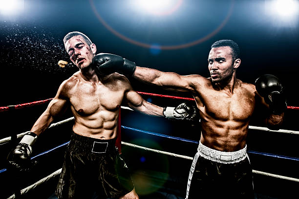 Boxing combat Boxer punching the face of his opponent knockout stock pictures, royalty-free photos & images