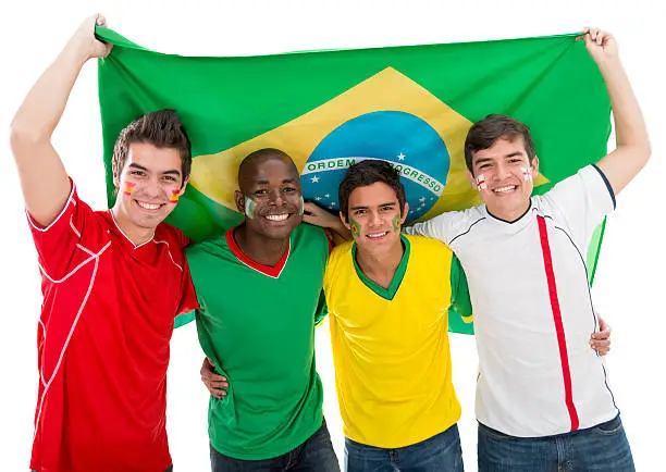 Happy football fans with the flag from Brazil