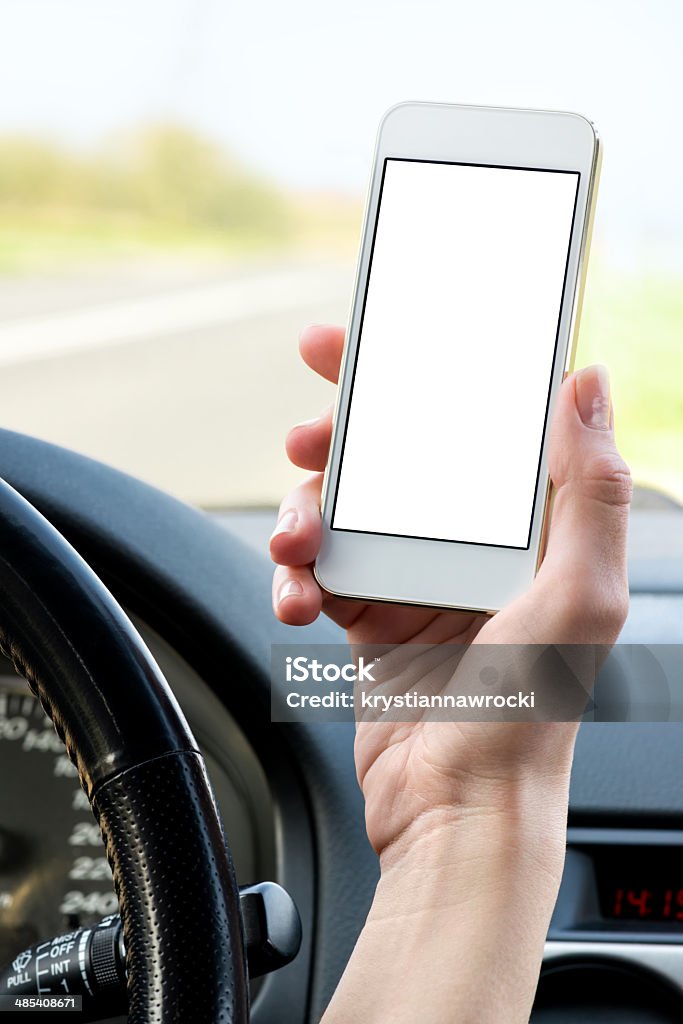 Using smart phone with a blank screen Woman using a white phone in a car. Device display a Blank Screen. Adult Stock Photo