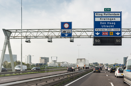 Traffic Jam on the right lanes, while trucks go past on the special truck lane on the left. This highway is part of the ring road around the city of Rotterdam.