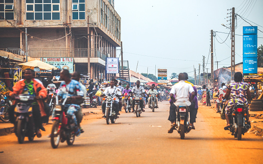 Motorcycle traffic in busy streets of African town.