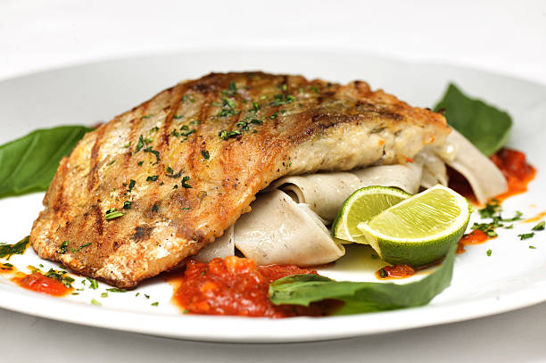 istock Fish with sauce and greens 485411741