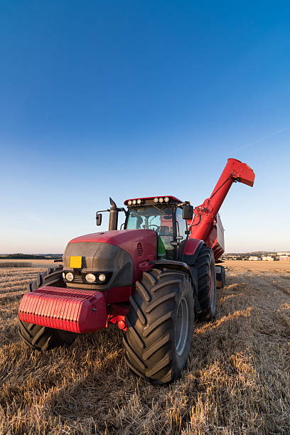 istock Agriculture tractor and trailer on a stubble field 485412506