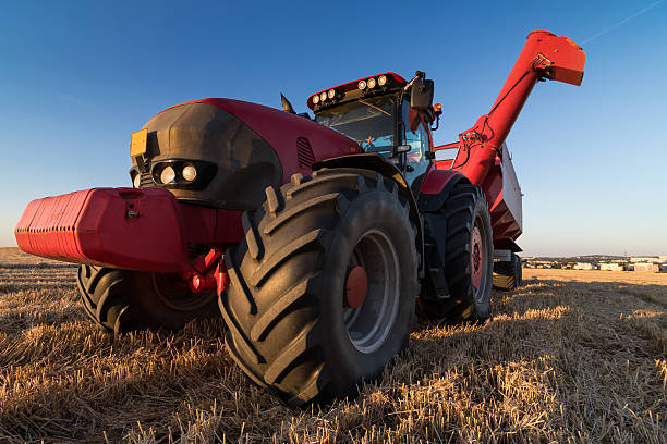 istock Agriculture tractor at stubble field 485412520