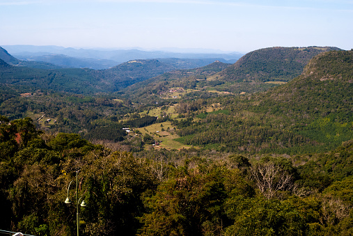 Clear sky over Three sisters rock formation in Blue Mountains of Australia in aerial vertical panorama over Echo point lookout.