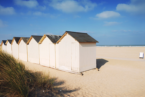 Sandy beach  with cabins and grasses in Ouistreham ,Normandy,France.