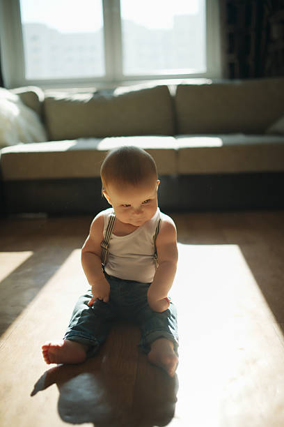 istock cute little boy sitting on the floor 485413966