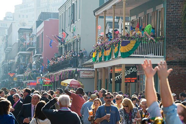 Mardi Gras in New Orleans Crowds at Mardi Gras on Bourbon Street in New Orleans, Louisiana new orleans mardi gras stock pictures, royalty-free photos & images