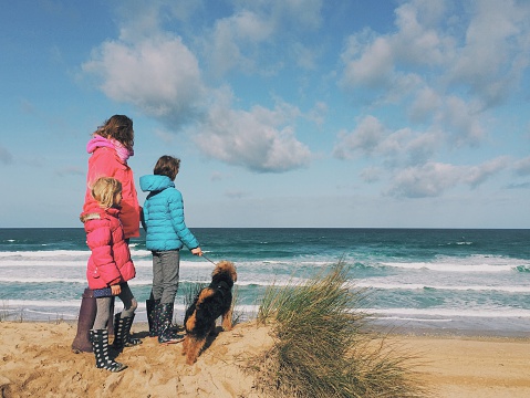Family with dog looking out to sea