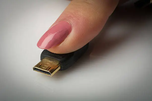 To get an idea of scale a woman puts her index finger on the connector